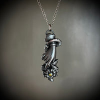 Sentimental Hand Holding a Daisy Necklace with Gunmetal Patina