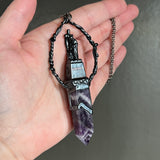 Woman with a Cross and Banded Amethyst Necklace with Gunmetal Patina