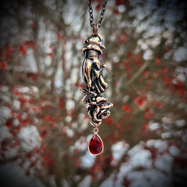 Pierced Hand Holding a Rose Copper Necklace