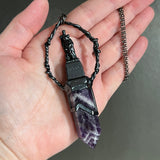 Woman with a Cross and Banded Amethyst Necklace with Gunmetal Patina