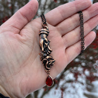 Pierced Hand Holding a Rose Copper Necklace