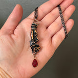 Pierced Hand Holding a Rose Copper Necklace