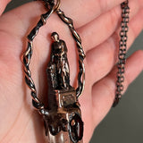 Woman Holding an Anchor with Smoky Quartz and Garnet Copper Necklace